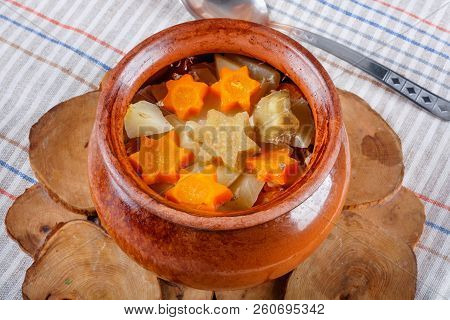 Traditional Rustic Home  Gulyas, With Raw Vegetables And Spices In Clay Pots On  Old Vintage Wooden 