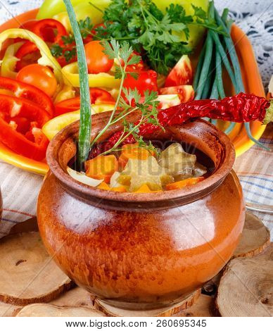 Traditional Rustic Home  Gulyas, With Raw Vegetables And Spices In Clay Pots On  Old Vintage Wooden 