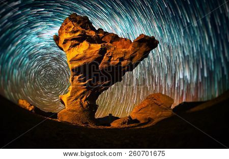 Starry sky with the star trails like comets and rock formation named Arbol de Piedra (Stone Tree) in Eduardo Avaroa Andean Fauna National Reserve of Sur Lipez Province, Bolivia. Tilt shift effect.