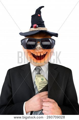 Portrait Of Jack Lantern  From Pumpkin In Black Business Suit. Jack Lantern Keeps Money In His Hands