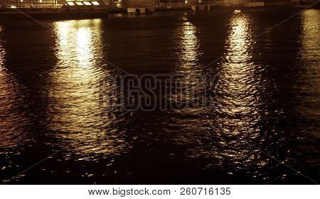 Water Ripple On The Night With Yellow Light Reflection From The Port In Central Java Indonesia