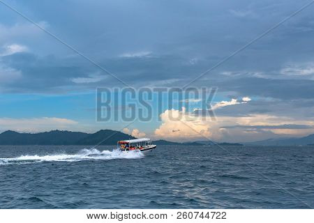 The Boat With Tourists Leaves The Mamutik Island, Sabah, Malaysia.