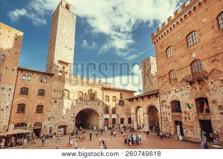San Giminiano, Italy - Sep 19: Crowd Of Tourist Watching Brick Towers Under Blue Sky In Historical I