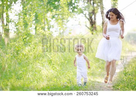 Mother And Son Having Fun Running And Playing Together At The Patk.