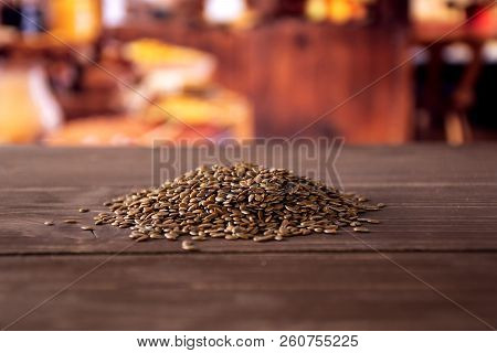 Lot Of Whole Fresh Brown Flaxseeds Heap With Rustic Wood Kitchen In Background