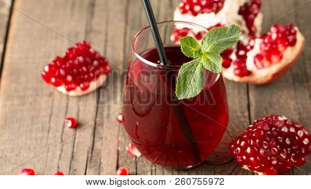 A Glass Of Pomegranate Juice With Fresh Pomegranate Fruits On Wooden Table. Vitamins And Minerals. H