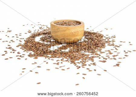 Lot Of Whole Fresh Brown Flaxseeds With Wooden Bowl Isolated On White Background
