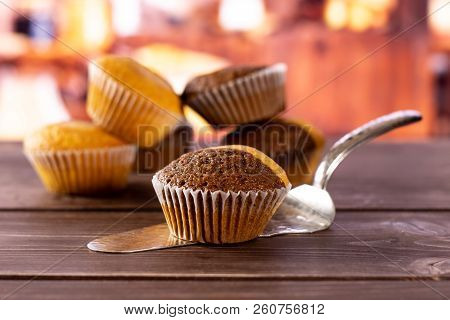 One Whole Fresh Baked Marble Muffin On Silver Cake Server With Rustic Wood Kitchen In Background