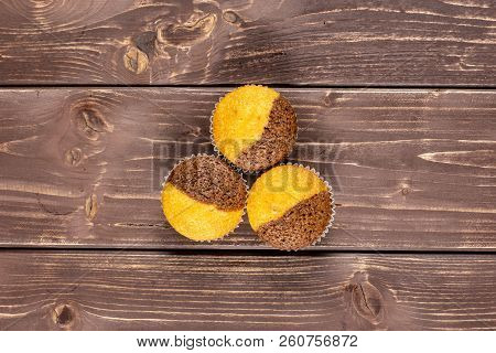 Group Of Three Whole Fresh Baked Marble Muffin Flatlay On Brown Wood