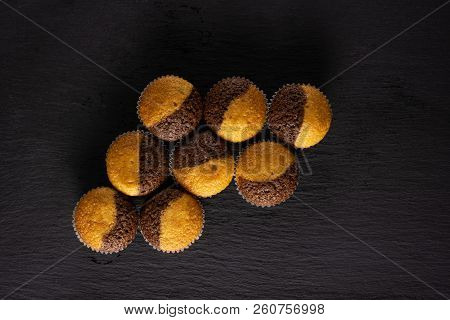 Group Of Eight Whole Fresh Baked Marble Muffin Flatlay On Grey Stone