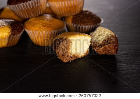 Group Of Lot Of Whole Two Halves Of Fresh Baked Marble Muffin On Grey Stone