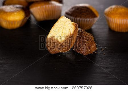 Group Of Lot Of Whole Two Halves Of Fresh Baked Marble Muffin On Grey Stone