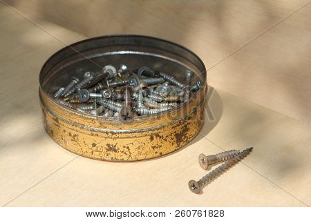 Metallic Box With Screws And Nails Instruments.