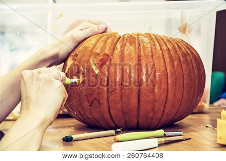 Women's Hands Who Cuts Jack-o-lantern With Knife