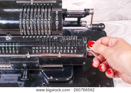 Old Rusty Retro Calculator Black Standing On A Wooden Table. Keyboard Of Arithmometer
