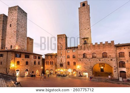 San Giminiano, Italy - Sep 19: Towers And Traditional Houses On Square Of Ancient Tuscan Town In Eve