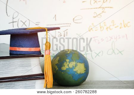 Education Graduate Mortarboard Blue Hat On Textbook With Formula Equation Mathematics On Screen Near