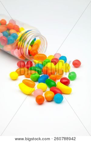 Candies Of Fruit Flavors Spilled On A White Background