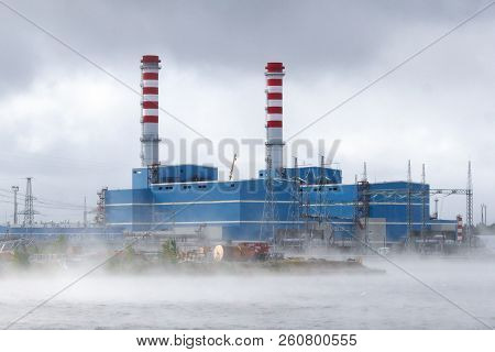 A Modern Ccgt Thermal Power Plant In A Fog On The Shore Of A Cooling Reservoir.