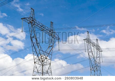 Mast Of The Power Line Against The Blue Sky.