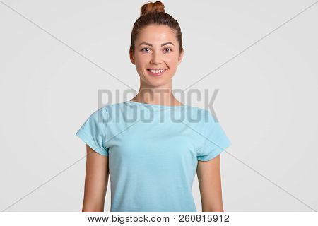 Portrait Of Happy Teenage Girl With Toothy Smile, Delighted Expression, Wears Casual T Shirt, Being 