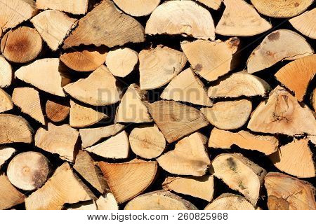 Wooden Log Texture Background With Different Type And Sizes Of Logs For Firewood Put On One Large Pi