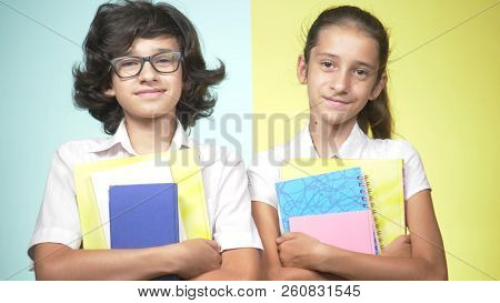 Portraits Of Children In School Uniform On A Colored Background. Funny Children. Sister And Brother.