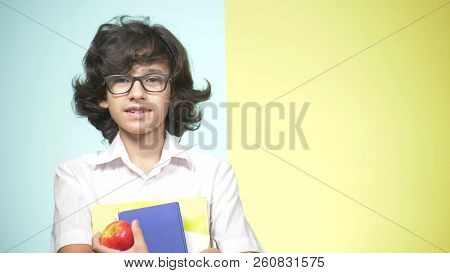 Portraits Of A Teenage Boy In School Uniform On A Colored Background. Funny Guy. Concept Of Learning
