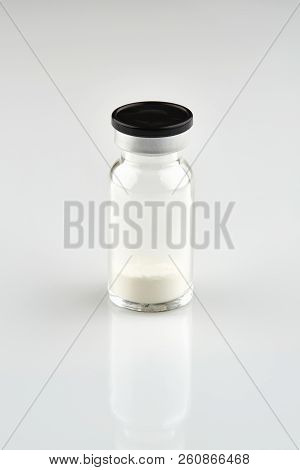 Small Sealed Bottle With Medicine On White Background.