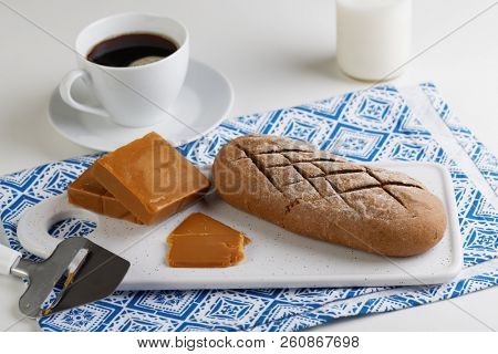 Norwegian breakfast with Brunost cheese, bread, and coffee
