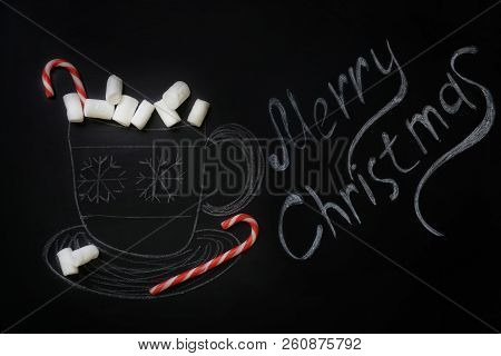 A Chalk-drawn Mug Of Hot Chocolate With A Real Candy Cane And Real White Marshmallows On A Chalkboar