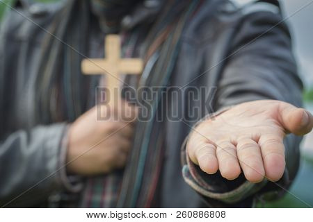 Human Hand Holds Cross And Open Palm Up Worship. Eucharist Therapy Bless God Helping Repent Catholic