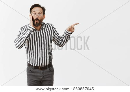Portrait Of Impressed And Thrilled Gay Man With Beard And Moustache, Folding Lips In Curious Emotion