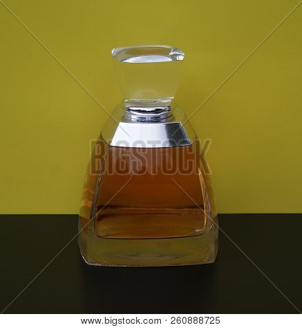 Fragrance For Ladies, Large Perfume Bottle In Front Of Yellow Background