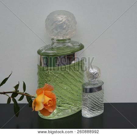 Fragrance For Ladies, Large Perfume Bottle Next To A Commercial Perfume Bottle Decorated With An Eng