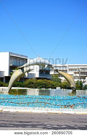 Albufeira, Portugal - June 12, 2017 - Three Dolphin Fountain In The Centre Of A Traffic Island, Albu