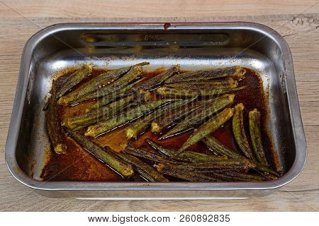 Lichfield, Uk - May 1, 2017 - Spicy Oven Roasted Okra In A Stainless Steel Roasting Dish, England, U