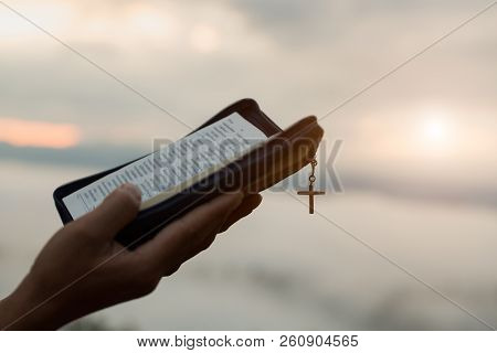 Human Hand Holds  Bible, Worship, Sins And Prayer, Religious Concept., Eucharist Therapy Bless God H