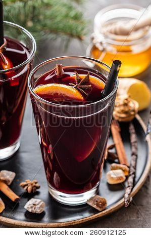 Hot Mulled Wine With Spices, Apple And Orange On Chrictmas Background. Copy Space.