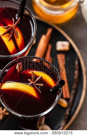 Hot Mulled Wine With Spices, Apple And Orange On Chrictmas Background. Copy Space.