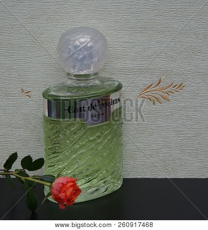 Eau De Rochas, Fragrance For Ladies, Large Perfume Bottle In Front Of The Satin Wallcovering Elysee 