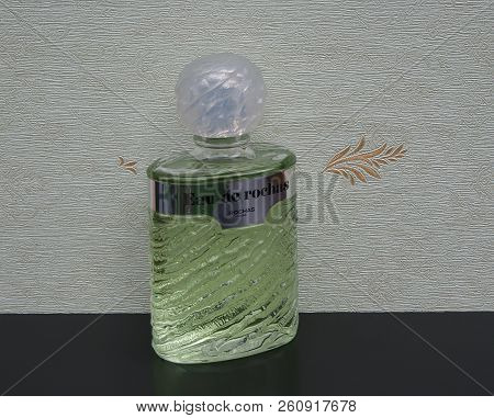 Eau De Rochas, Fragrance For Ladies, Large Perfume Bottle In Front Of The Satin Wallcovering Elysee