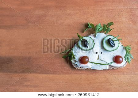 The Funny Sandwich On The Wooden Board