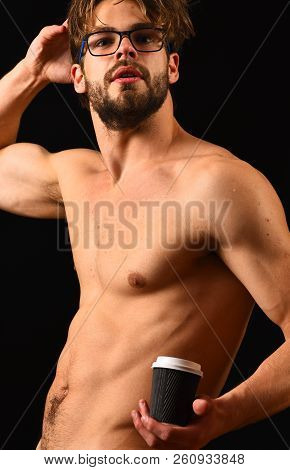 Macho Attractive Nude Guy Hold Hot Coffee. Man Smart And Sexy With Beard And Tousled Hair Wears Eyeg