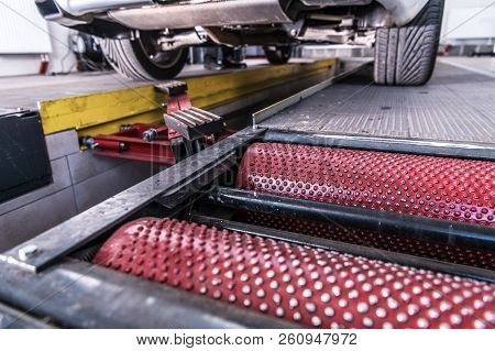 Vehicle Braking System Check Using Roller Tester. Car Inspection.