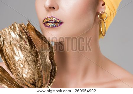 Cropped Shot Of Sensual Woman With Shiny Lips Holding Golden Protea Flower Isolated On Grey