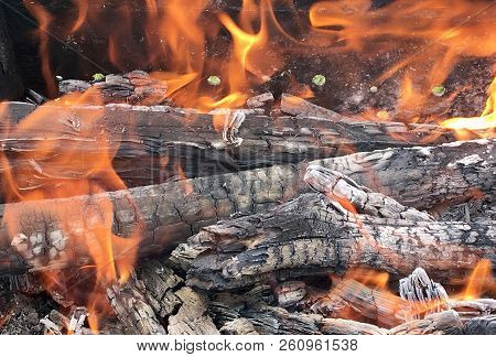 Beautiful Red Flame From Slice Wood, Dark Grey Black Coals Inside Metal Brazier. Wood Burning In The
