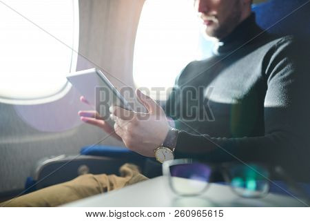 Mid Section Portrait Of Unrecognizable Man Using Digital Tablet While Enjoying Long First Clas Fligh
