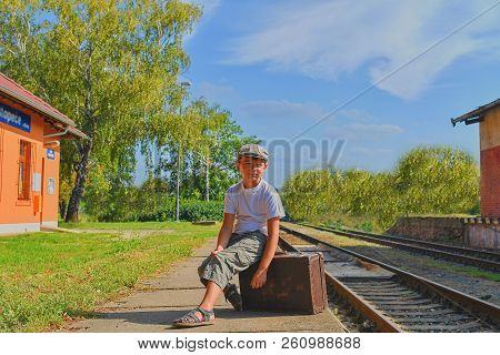 Little Boy  On A Railway Station, Waiting For The Train With Vintage Suitcase. Traveling, Holiday An