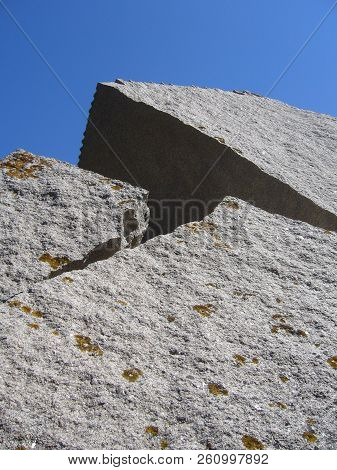 Granite Rocks Closeup, Natural Texture Pattern With Blue Sky In The Background